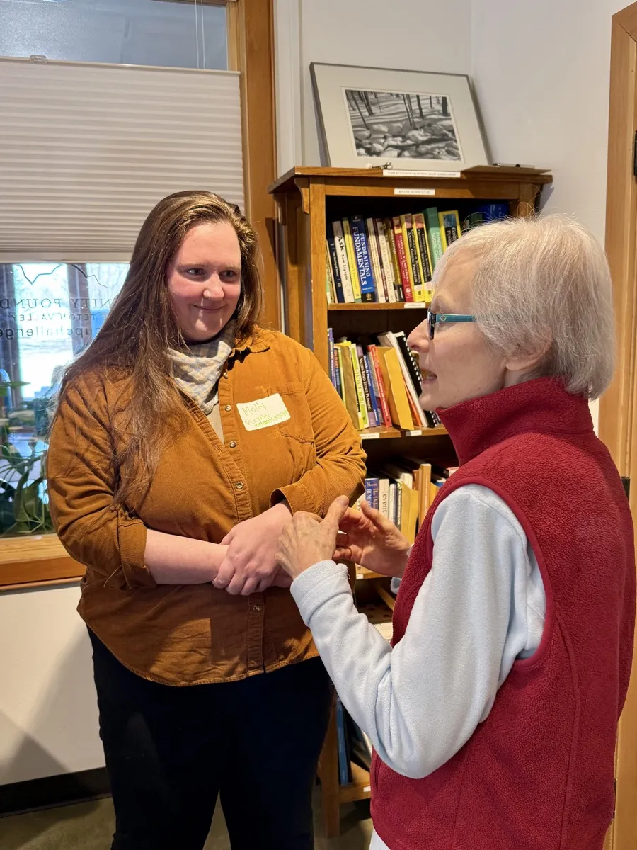 Community Foundation staff member warmly greeting a donor at the Driggs office