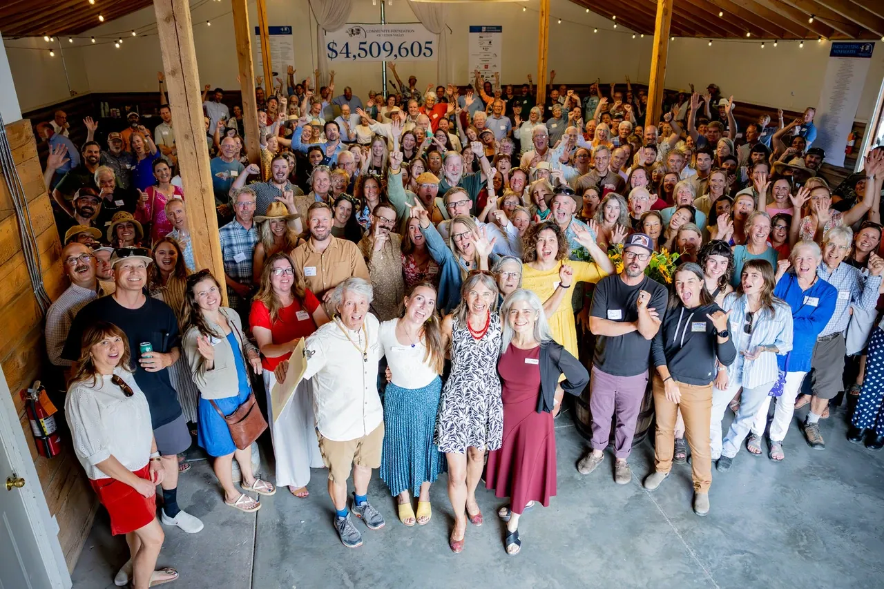 Tin Cup Challengers, nonprofit leaders, and volunteers cheering beneath a banner reading $4,509,605 at the 2026 Tin Cup Challenge Awards Celebration